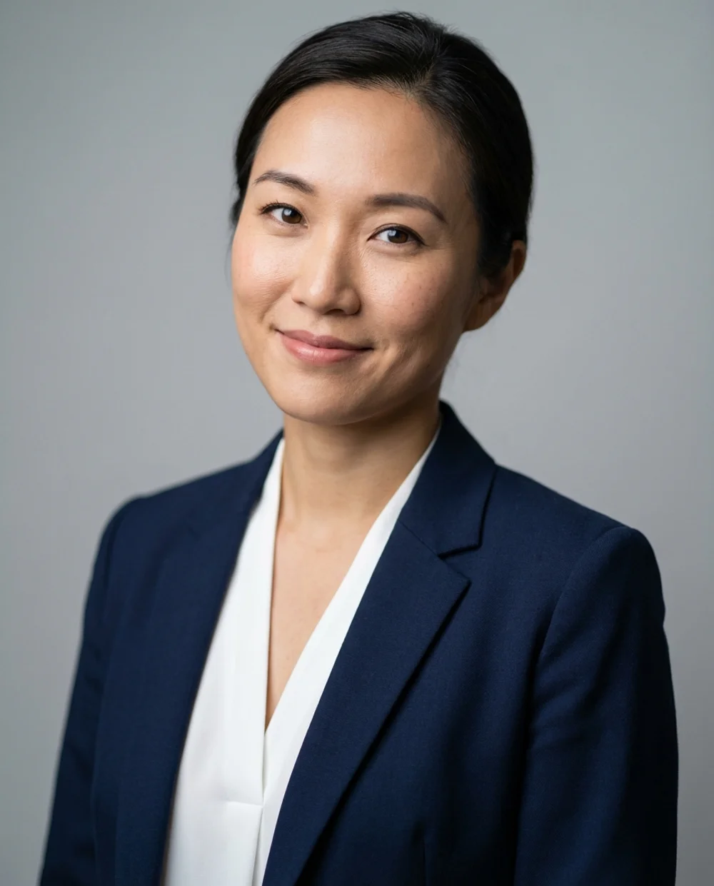 Professional headshot - woman in navy blazer